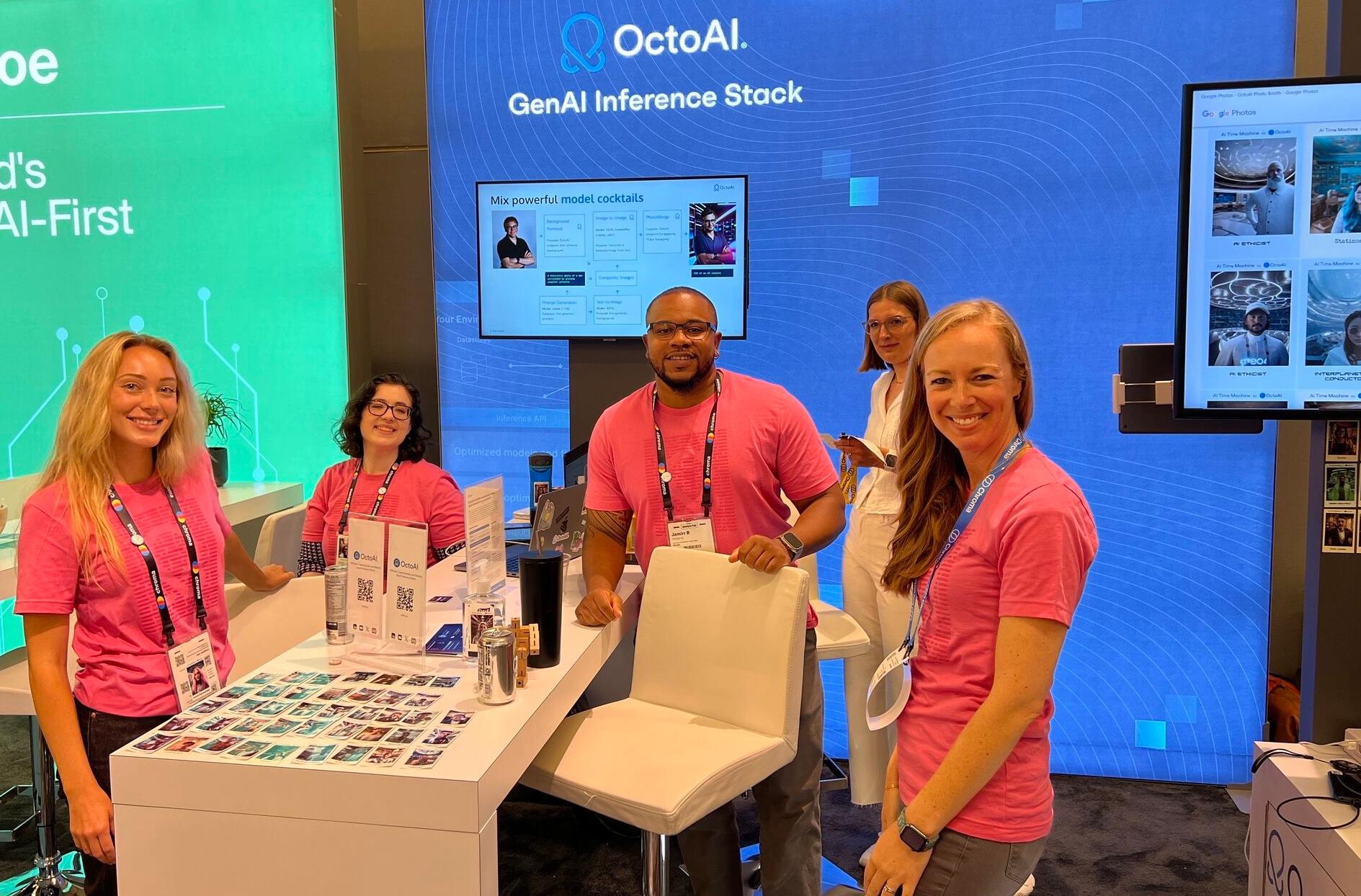 OctoAI team around table with printed out photos