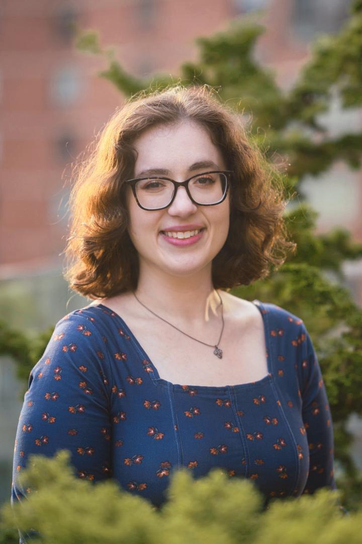 Headshot of smiling woman with glasses